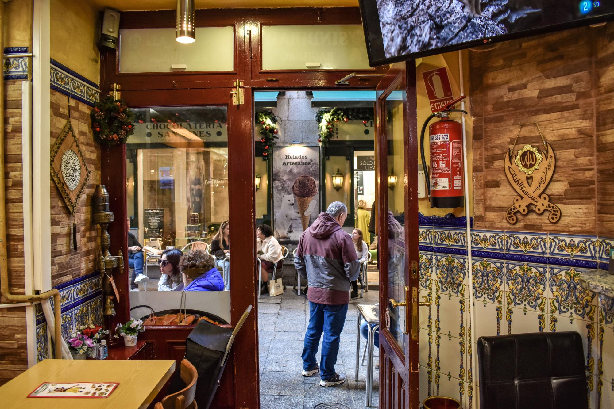 The view from inside the Arabic restaurant Sindibad Baghdad, which looks out on the Chocolatería San Ginés. The owner, who left Iraq at the time of the U.S.-led invasion, makes homemade baklava.