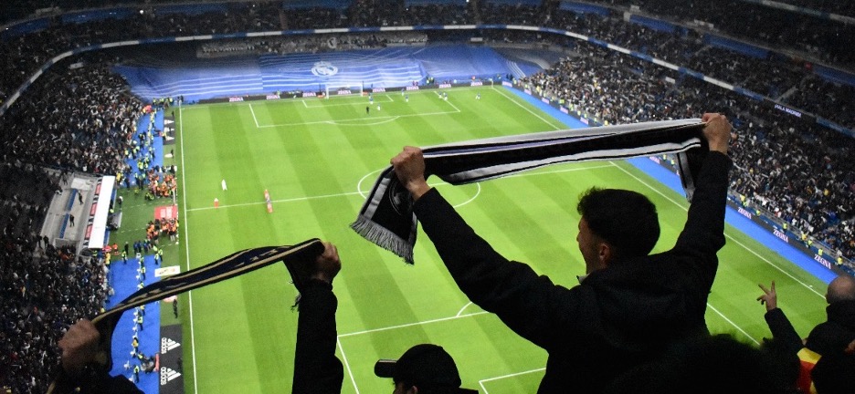 Fans cheer at a match between Real Madrid and Madrid rival Athletico at Santiago Bernabeu Stadium in Madrid.
