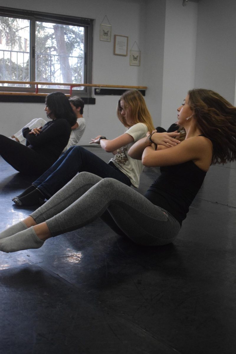 Students strengthen their muscles at the start of a recent dance class at the off-campus studio. 