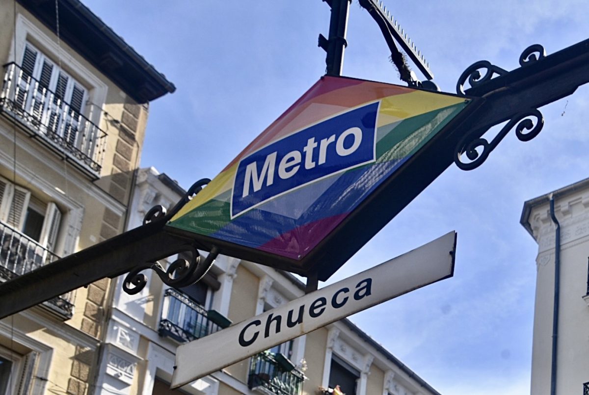 A metro entrance in the heart of Chueca displays the colors of the rainbow flag, one of many Pride symbols in the neighborhood.