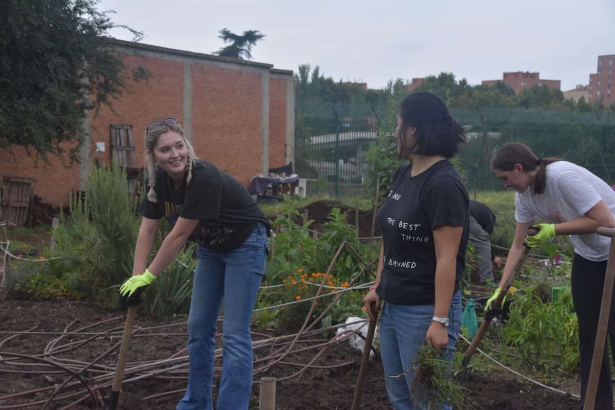 Alaina Stratton, a leader of the gardening club, and Lili McArdle, the SGA president, at the club plot at Huertos Montemadrid on Calle de Eduardo Barreiros. 