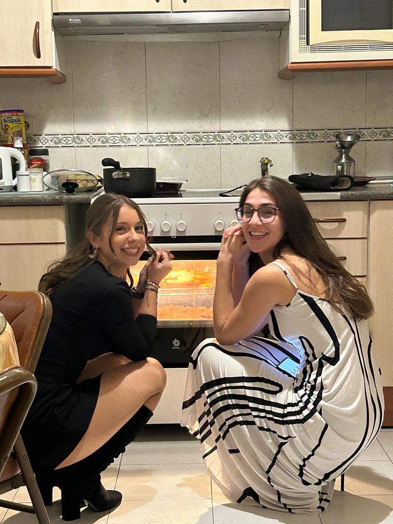 Lara Mitchell Guirao, a junior, watches the oven on Thanksgiving. 