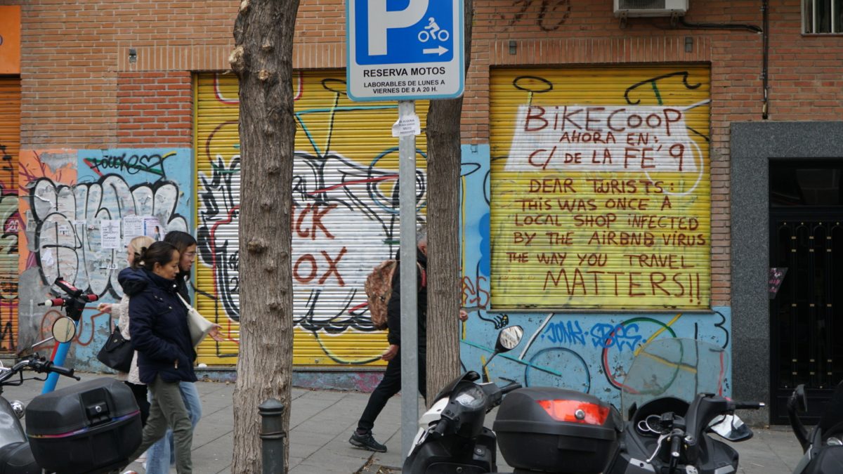 The spray-painted message on the doors of the closed down bike shop Alejandro Diaz worked at in Lavapiés.
