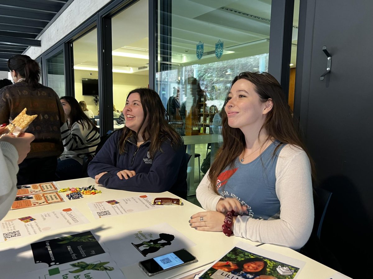 Community Gardening Club leader Mackenzie Oleary (left) and Green Bandana Project member Lucy Lally (right) talk to new students about their clubs.