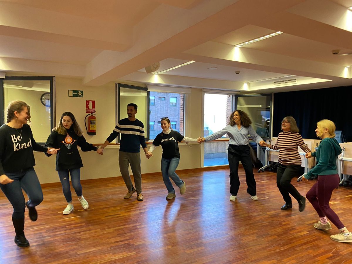 Workshop participants learn a Bulgarian dance.