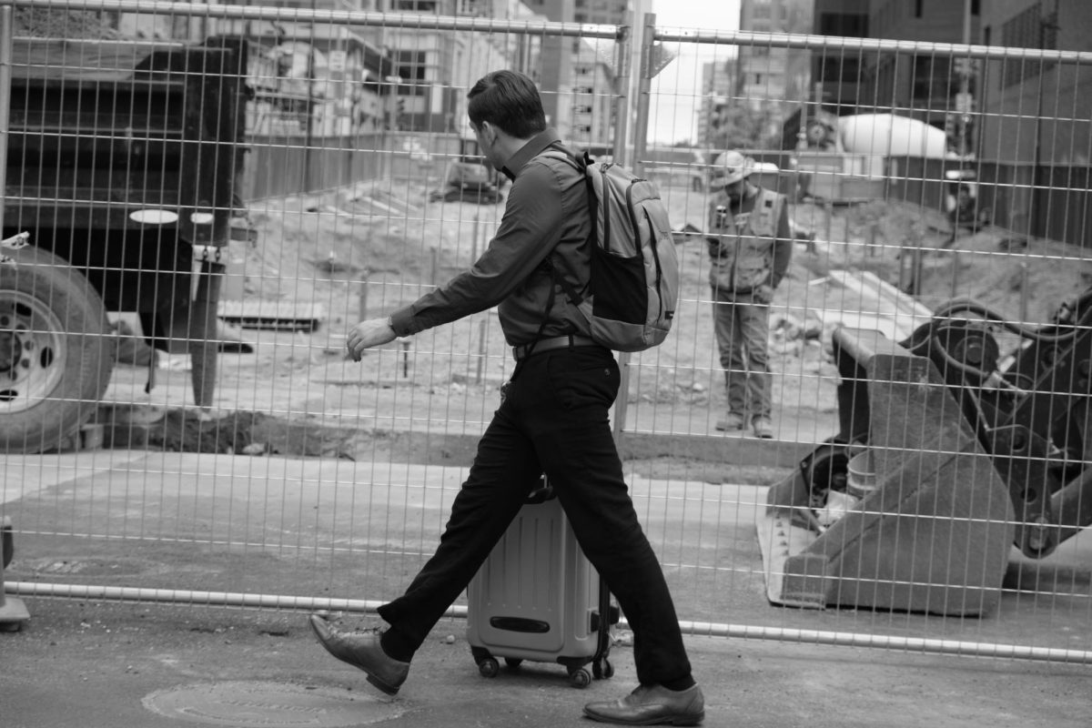 A man passes a construction site on 16th Street in downtown Denver, Colorado. Click on photo for full view.