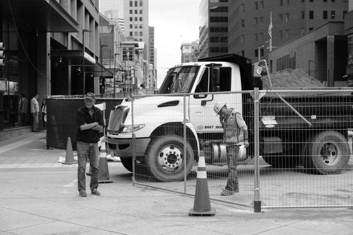 A worker chats with a pedestrian on 16th Street in downtown Denver, Colorado.