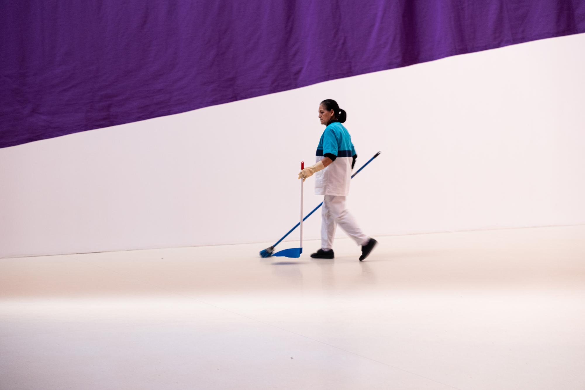 A woman sweeps the Palacio de Velazquez in Madrids Retiro park.