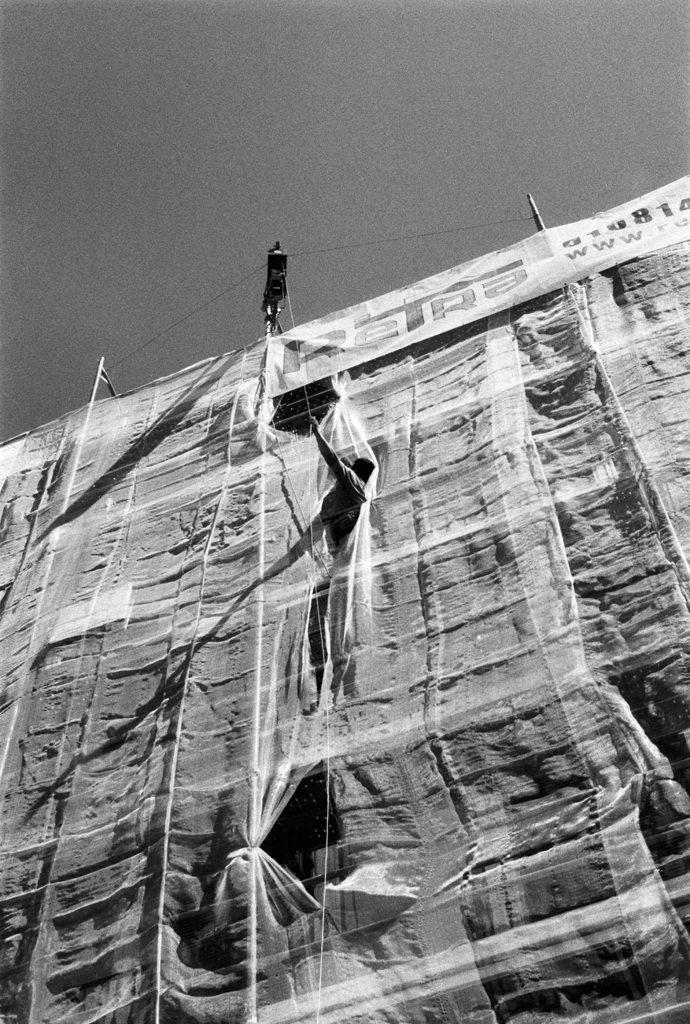 A man works the scaffolding of a building in the Barrio de las Letras, Madrid. 