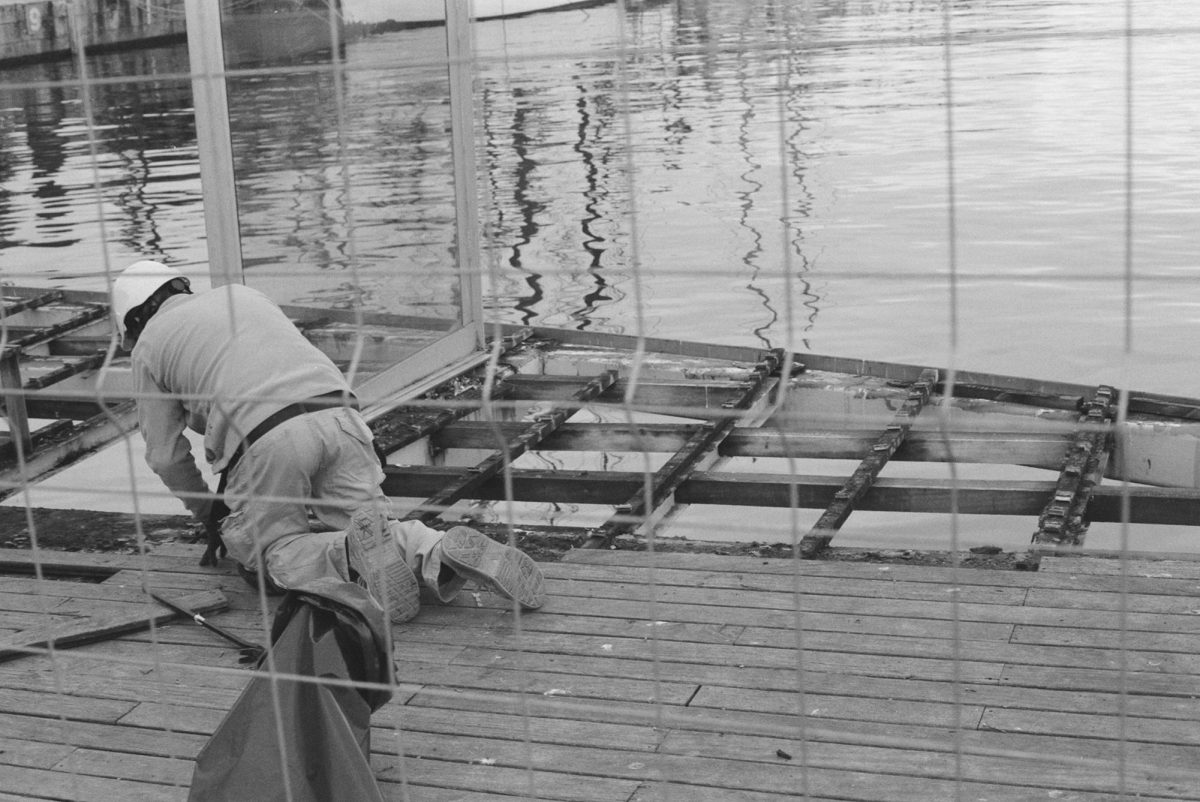 A man works on the pier of the Rambla de Mar in Barcelona.