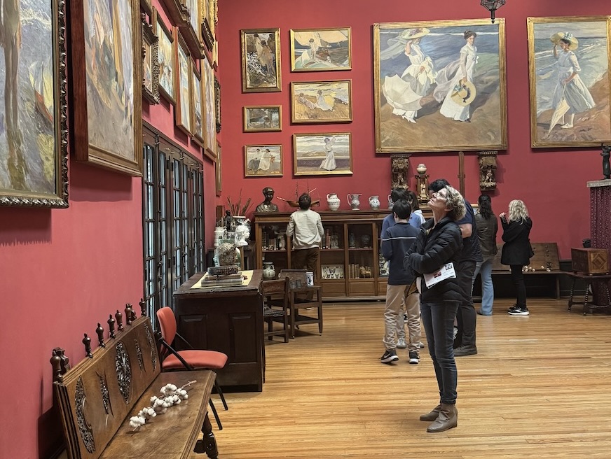 A woman looks up at paintings by artist Joaquín Sorolla in the Sorolla Museum.