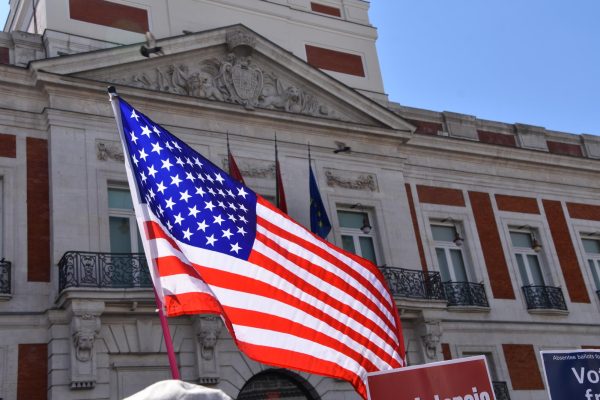 An American flag flies in the Puerta del Sol during a protest this spring against Trump's executive orders.