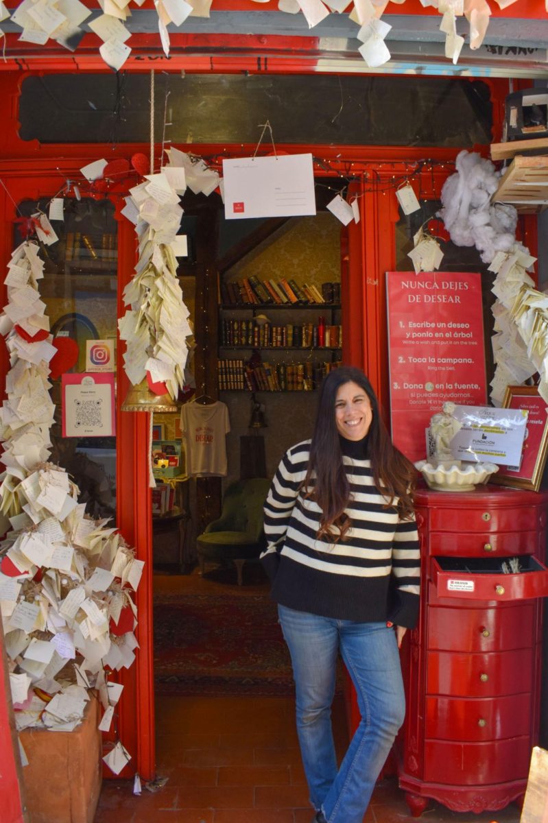 Daniela Camino, the owner of La Tienda de los Deseos stands outside her store, where visitors write their wishes and hang them on the wall.