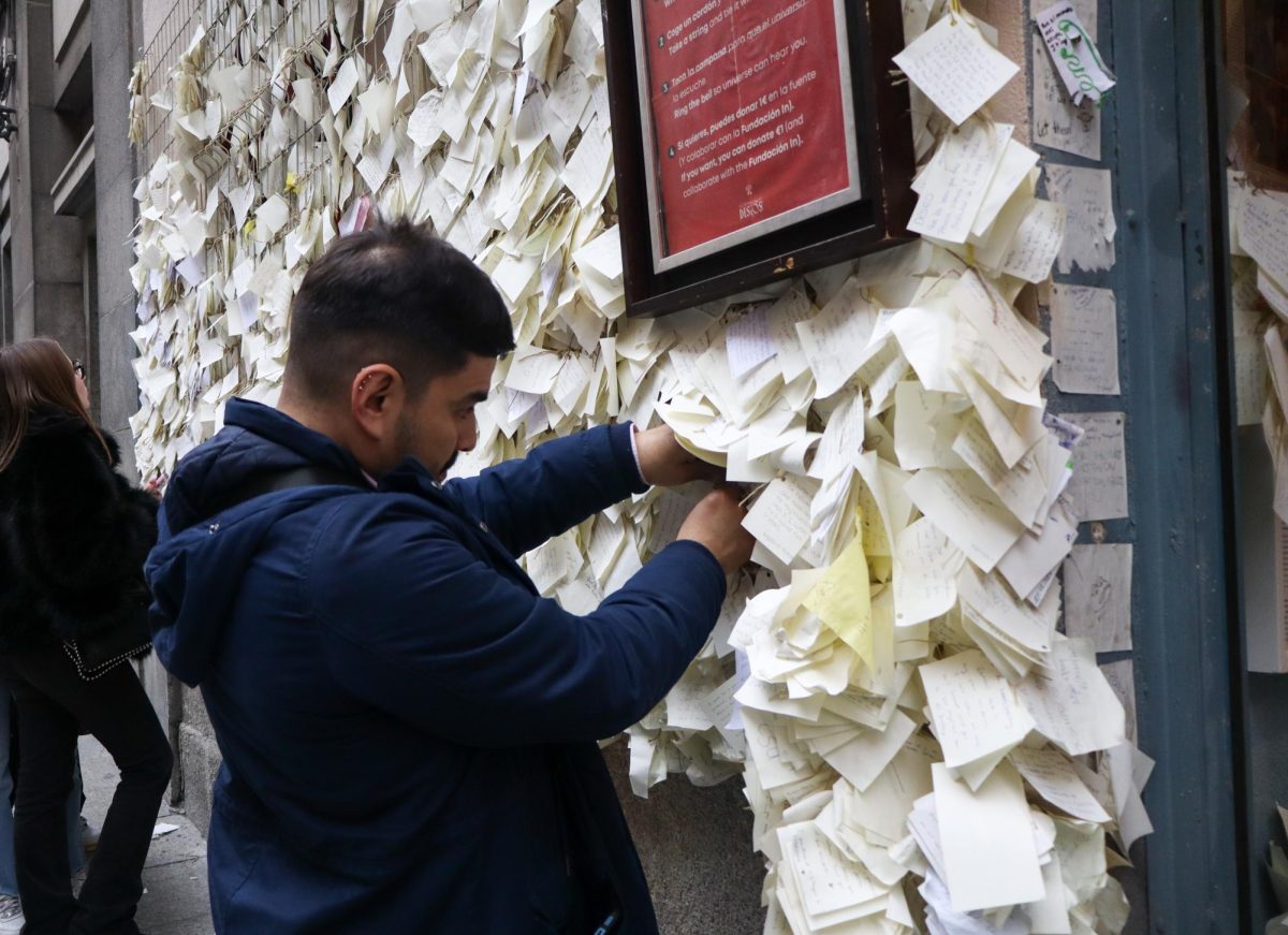 Andrés Cabrera ties a wish to the wall at La Tienda de los Deseos after visiting with his girlfriend. He noted that the visit brought a newfound sense of positivity into his day.