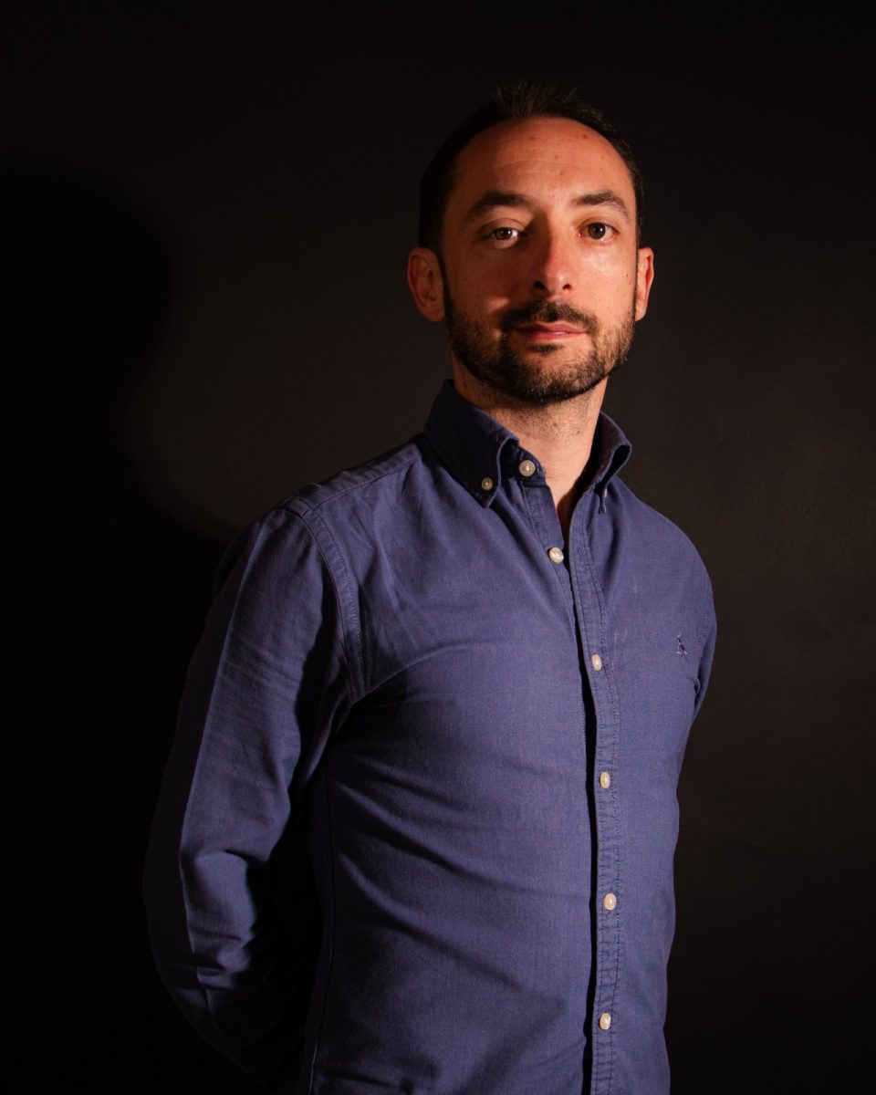 Sauras poses for a portrait in the Me- dia Lab studio. 