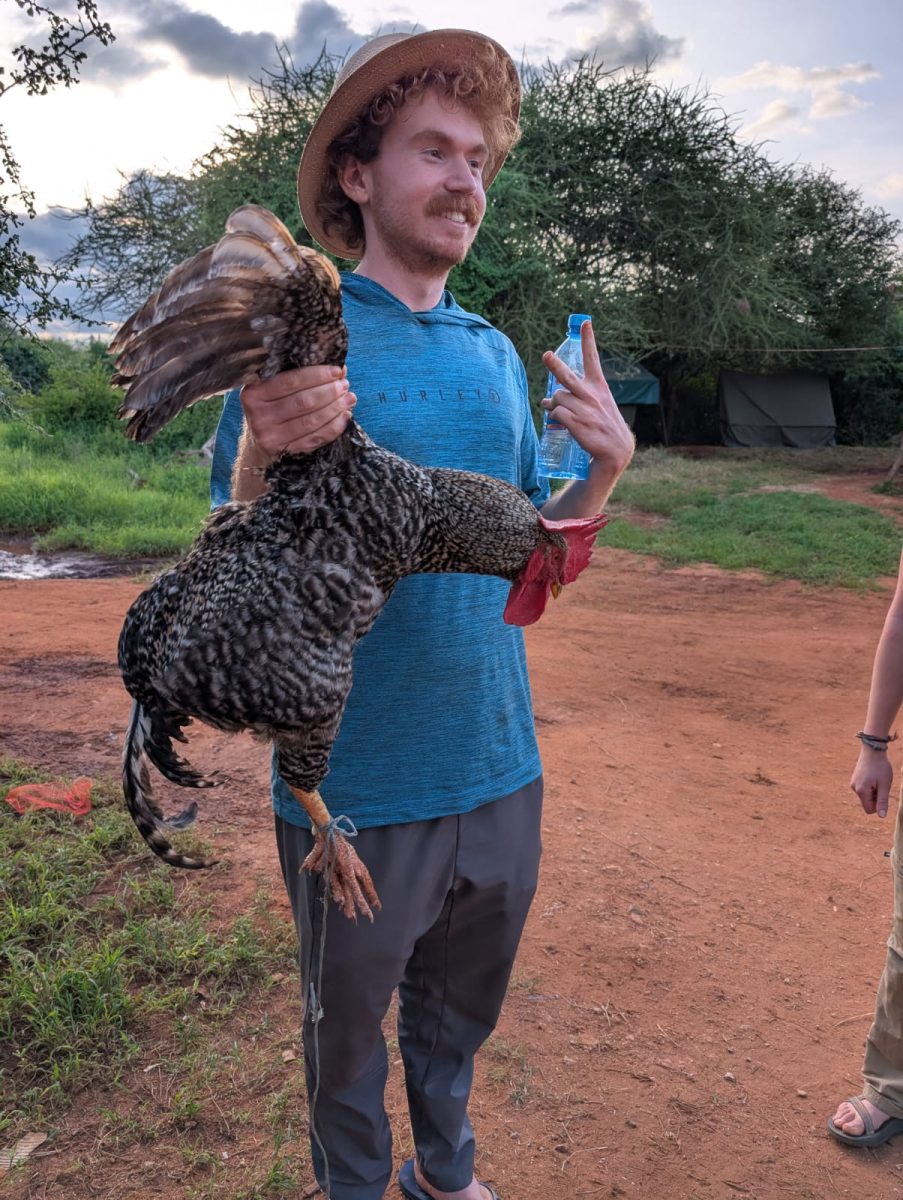 Student Joaquín Martinez holds a chicken before it becomes dinner.